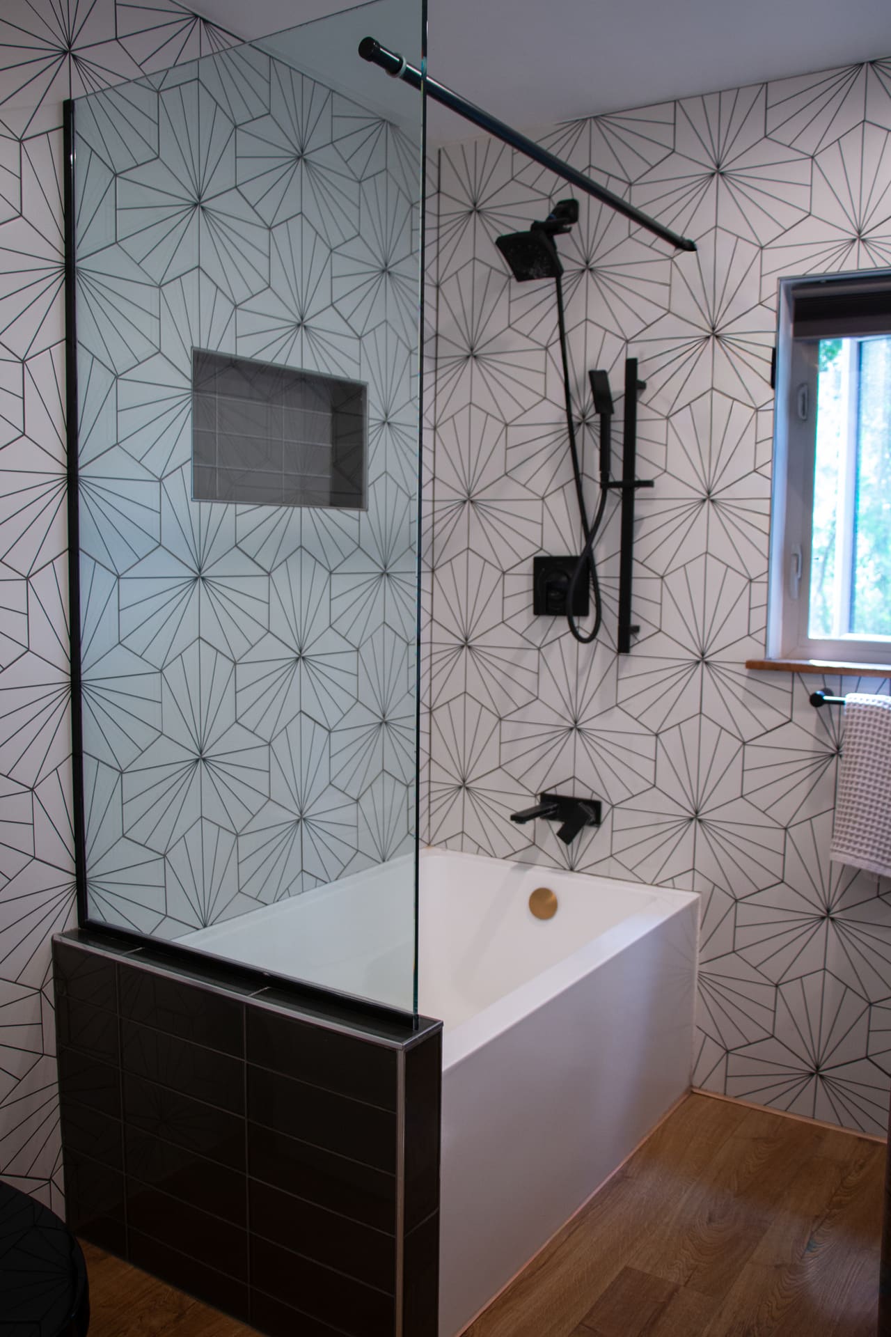 El Sereno Residence bath — geometric star-pattern tile, soaking tub, and matte black fixtures